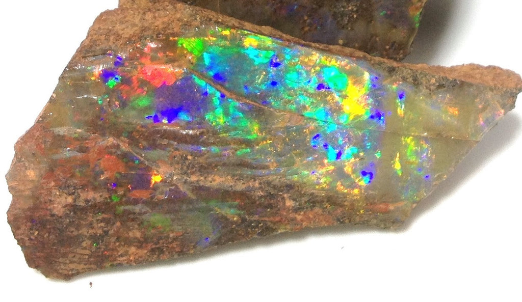 Bright red, orange, gold, green and violet Rough boulder opal