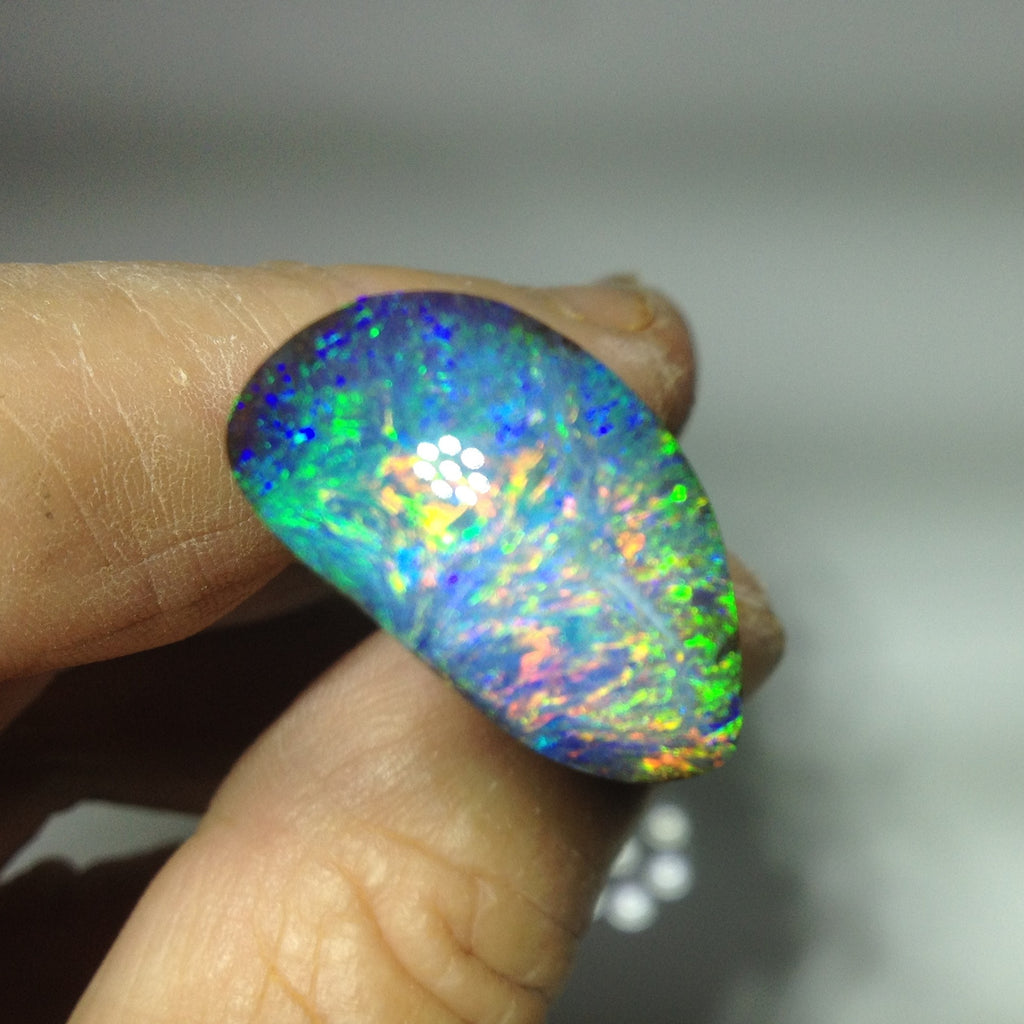 Green, orange, gold and blue solid boulder opal