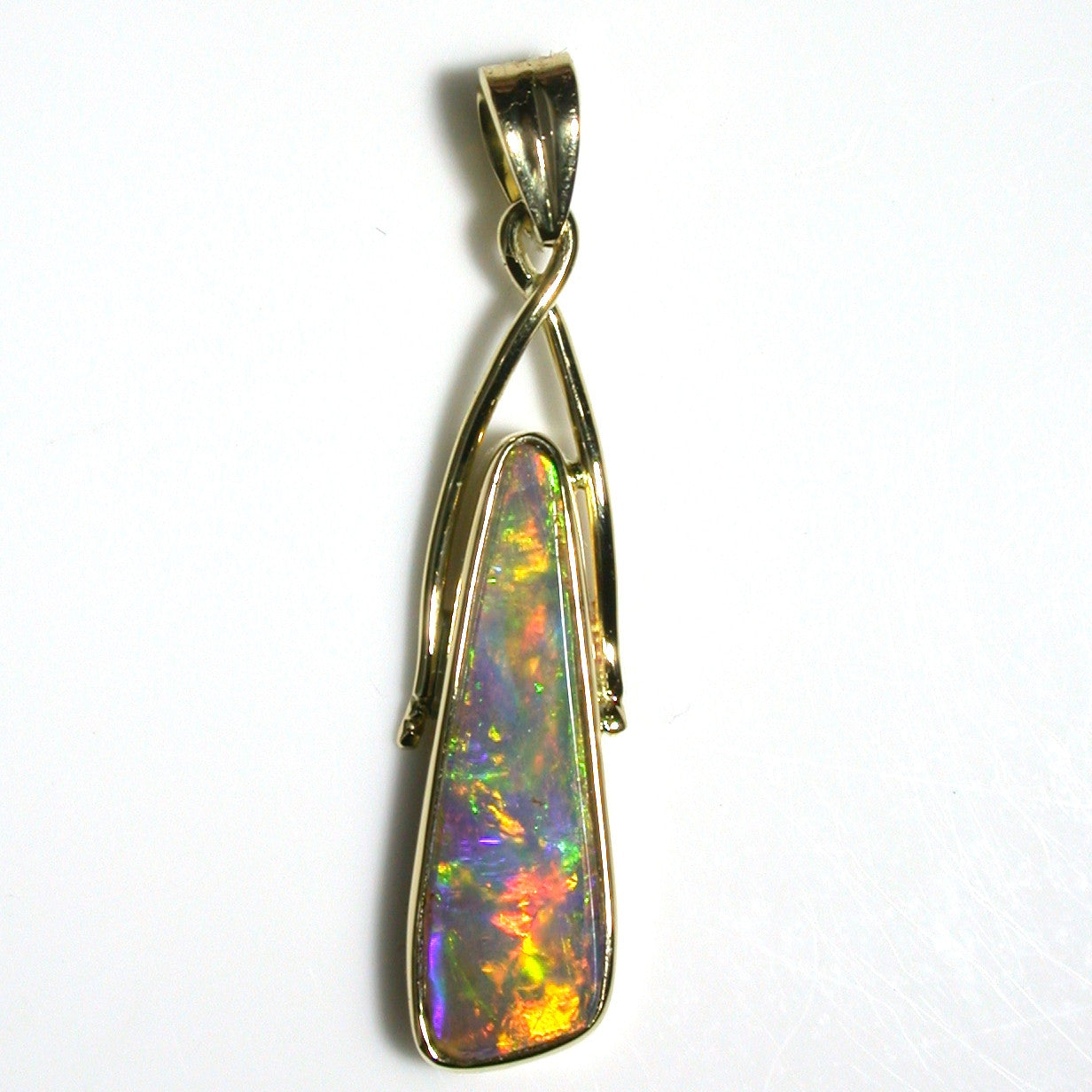 Green, orange, gold and violet solid boulder opal pendant