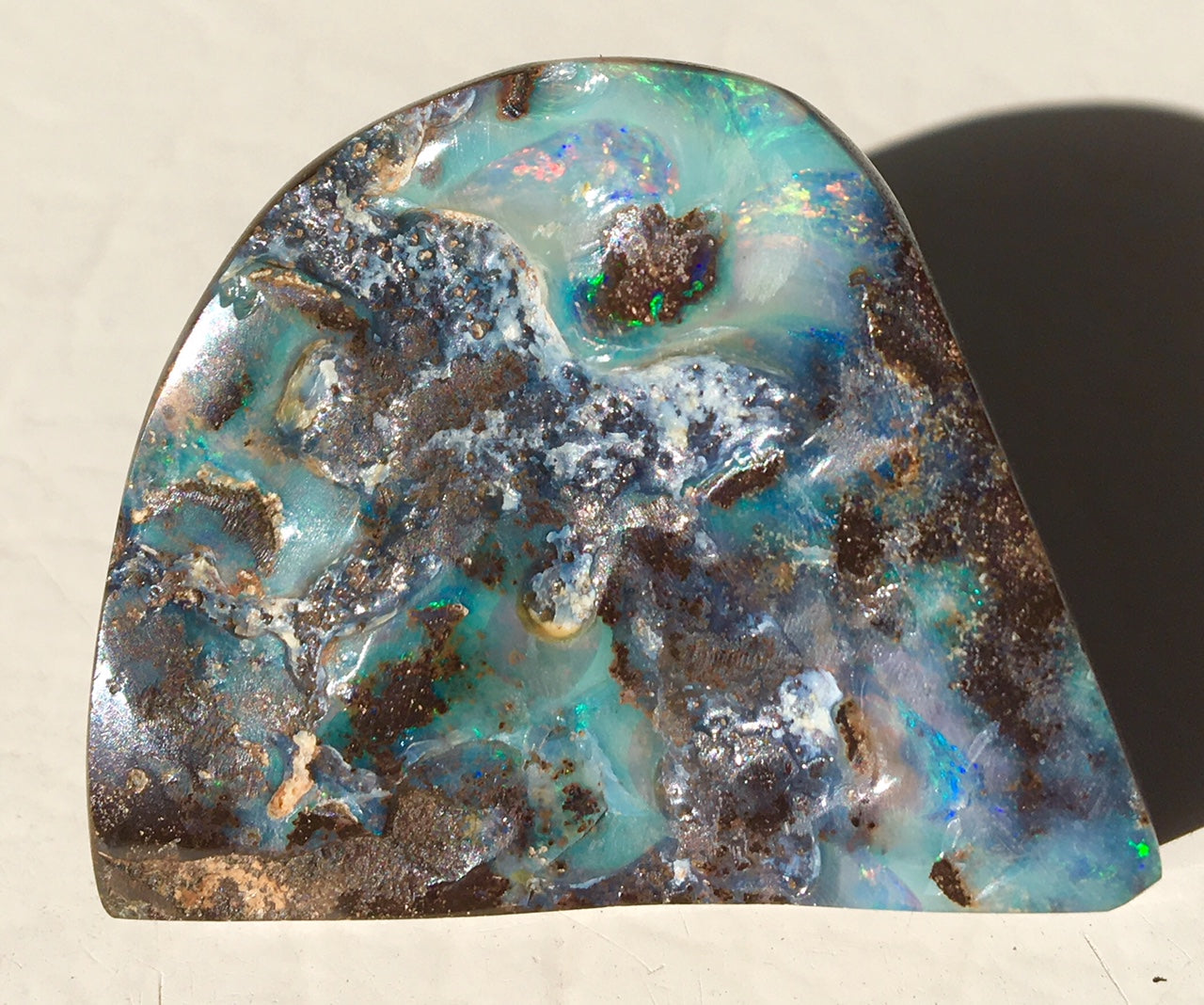 Green multi coloured boulder opal polished speciman