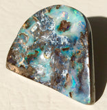 Green multi coloured boulder opal polished speciman