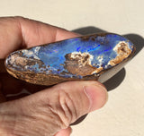 Violet boulder opal polished speciman