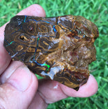 Rough boulder opal with green bars